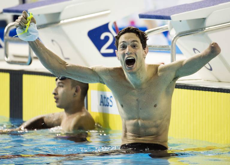 Facundo Lazo, right, of Argentina, celebrates winning the gold medal in front of silver medalist Armando Andrade, of Mexico, during the men's 100m breaststroke SB8 final at the Parapan Am Games in Toronto on Tuesday, August 11, 2015. THE CANADIAN PRESS/Darren Calabrese